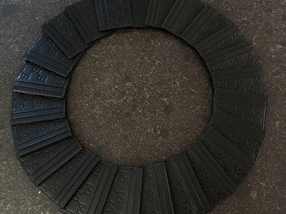 Black GG embossed cardholders arranged in a circle